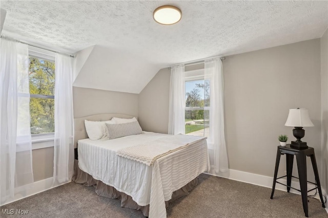 carpeted bedroom with a textured ceiling, baseboards, and vaulted ceiling