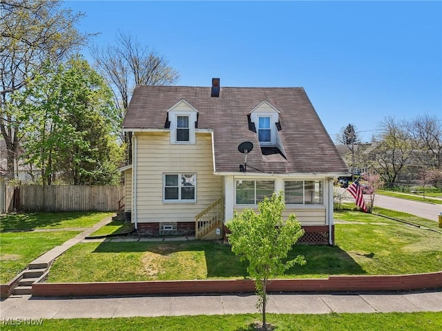 exterior space featuring a yard, fence, and a chimney