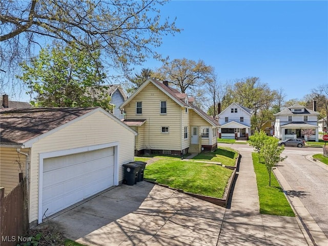 view of property exterior featuring driveway, a chimney, a lawn, a residential view, and an outdoor structure