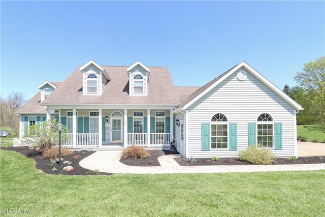 view of front of home with a porch, roof with shingles, and a front yard