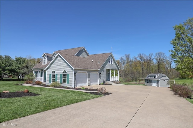 view of front of home with driveway, roof with shingles, a garage, an outdoor structure, and a front lawn