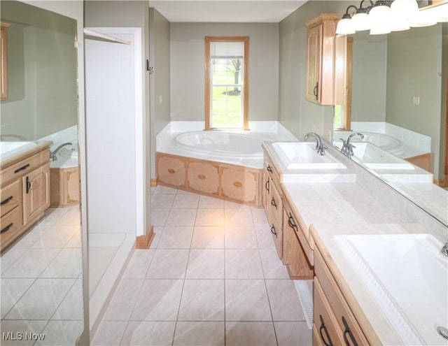 bathroom featuring vanity, tile patterned flooring, and a garden tub