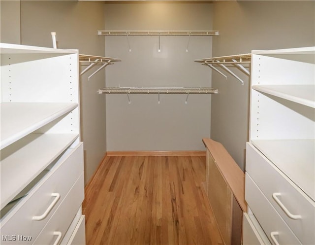 spacious closet with light wood finished floors