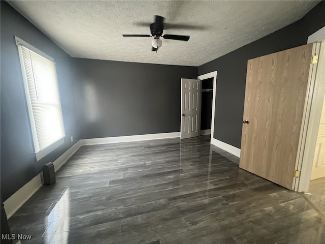 unfurnished bedroom with baseboards, ceiling fan, and a textured ceiling