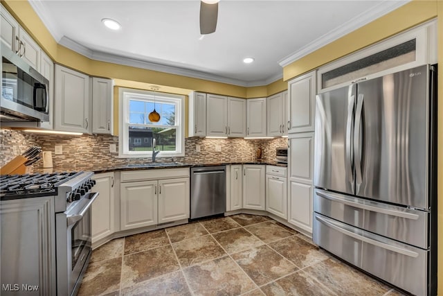 kitchen featuring crown molding, ceiling fan, a sink, backsplash, and stainless steel appliances