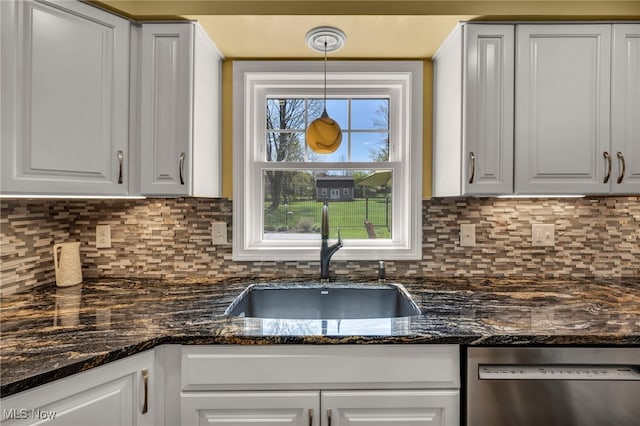 kitchen with a sink, white cabinetry, dishwasher, and tasteful backsplash
