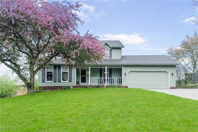 view of front of home with covered porch, a garage, a front lawn, concrete driveway, and a shingled roof