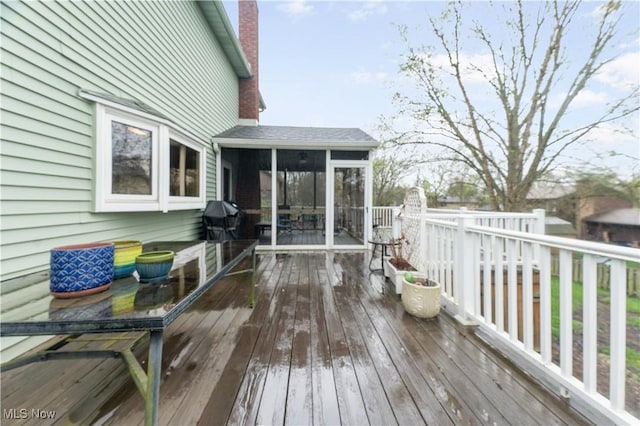 wooden terrace featuring a sunroom