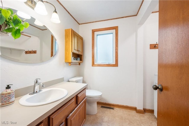 bathroom featuring visible vents, crown molding, vanity, baseboards, and toilet