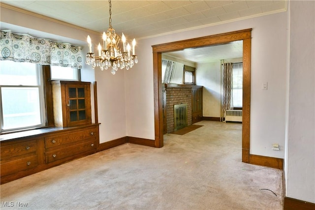 unfurnished dining area featuring baseboards, carpet, ornamental molding, and radiator