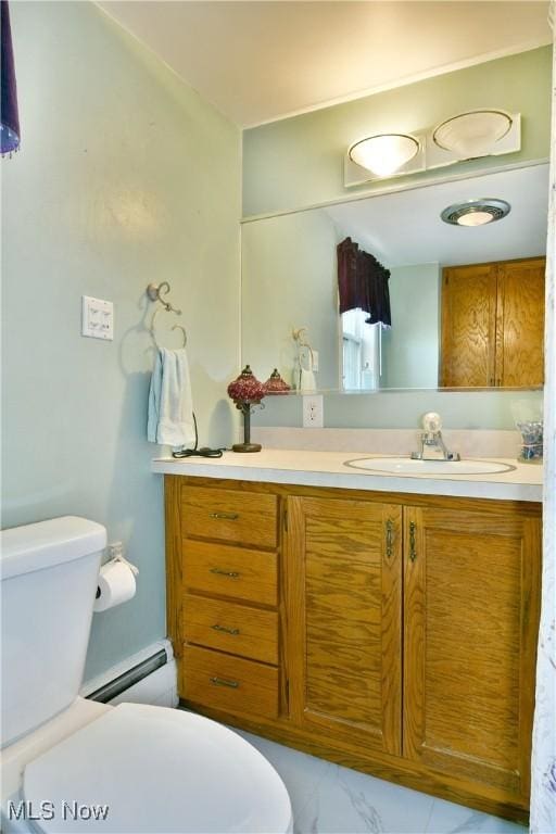 bathroom with vanity, toilet, marble finish floor, and a baseboard radiator