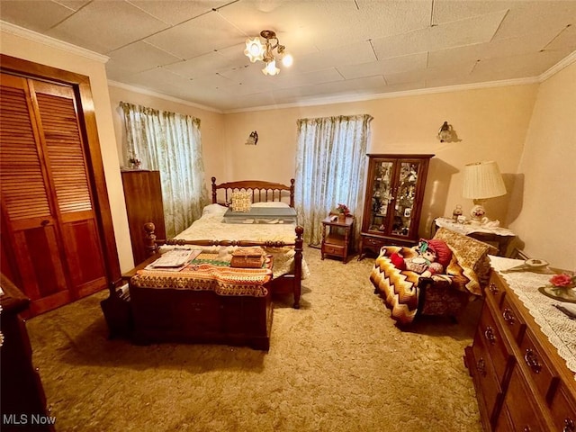 bedroom featuring carpet floors, ornamental molding, and a closet