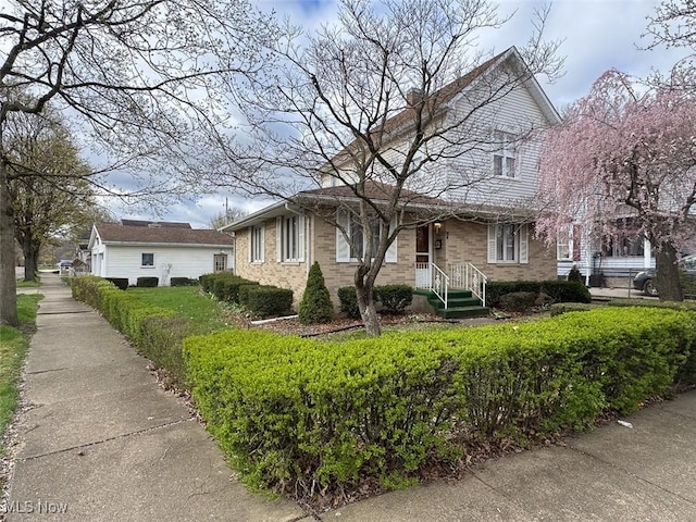 view of front of home featuring brick siding