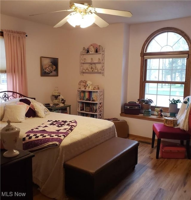 bedroom featuring a ceiling fan and wood finished floors