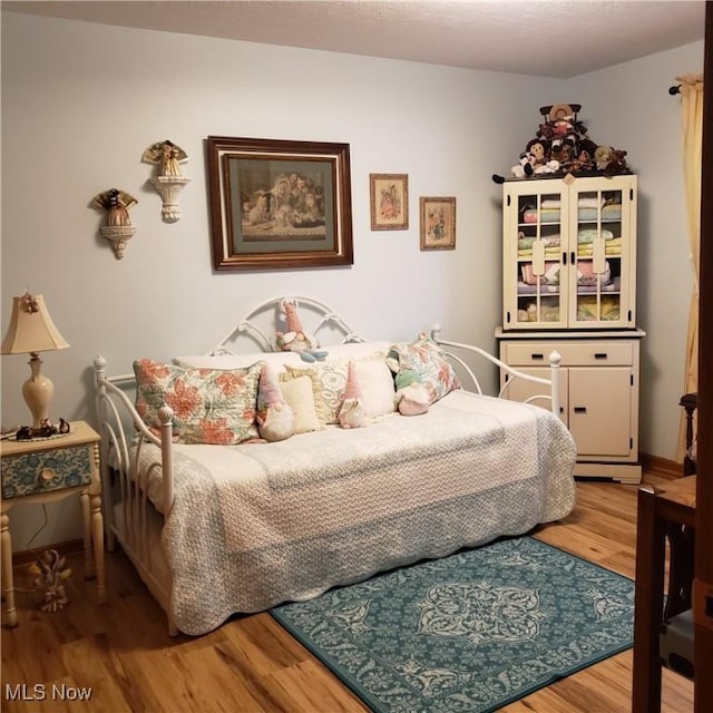 bedroom featuring wood finished floors
