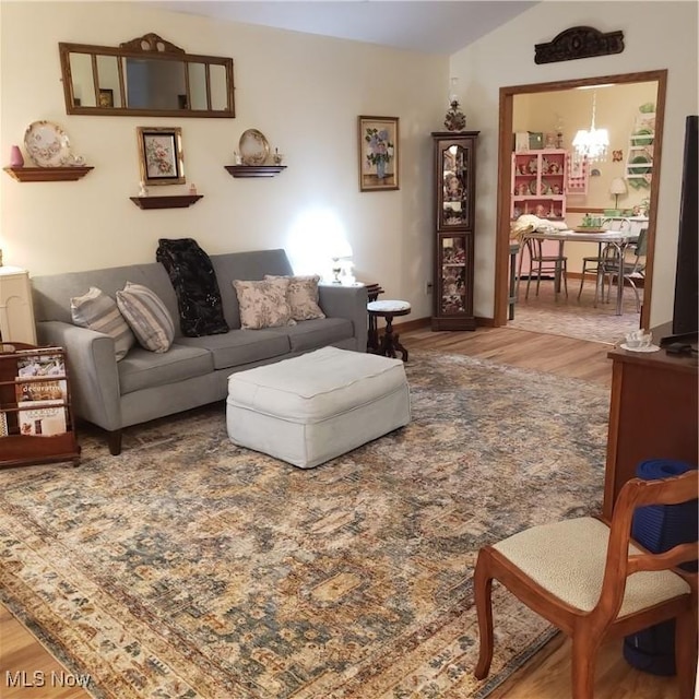 living area with an inviting chandelier and wood finished floors