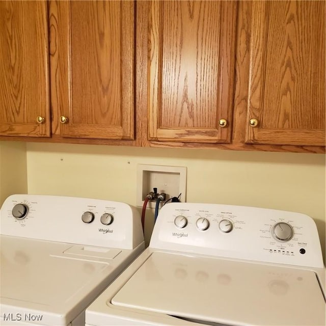 washroom with cabinet space and independent washer and dryer