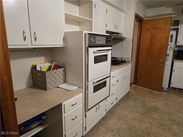 kitchen featuring light countertops, white cabinetry, under cabinet range hood, and white appliances