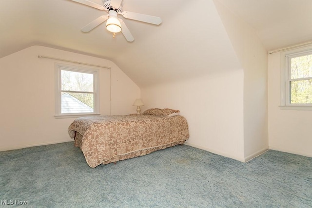 carpeted bedroom with a ceiling fan and lofted ceiling