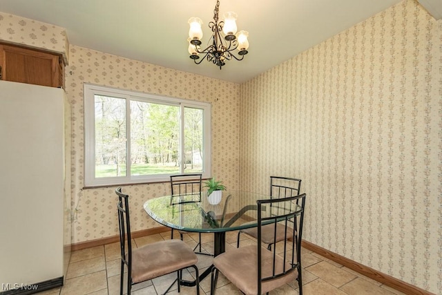 dining space featuring baseboards, light tile patterned floors, and a chandelier
