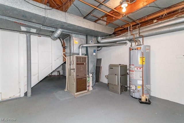 unfinished basement featuring concrete block wall, heating unit, and gas water heater