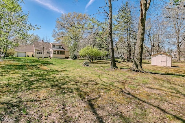 view of yard with an outbuilding, a shed, and a garage