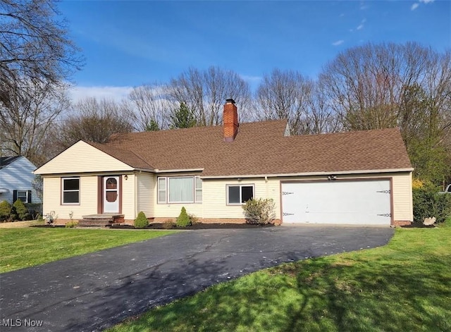 single story home with driveway, a chimney, roof with shingles, a garage, and a front lawn