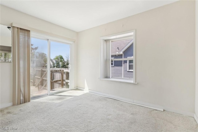 carpeted spare room with baseboards
