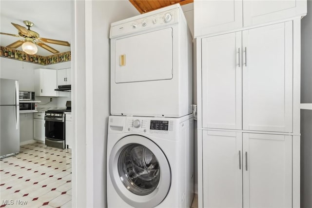 laundry room with stacked washing maching and dryer, light floors, ceiling fan, and cabinet space
