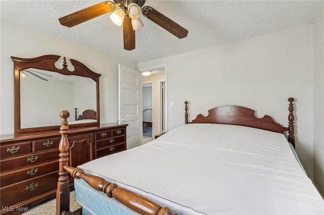 bedroom featuring a ceiling fan and a textured ceiling