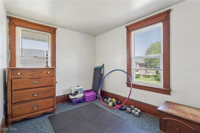 workout room featuring dark colored carpet