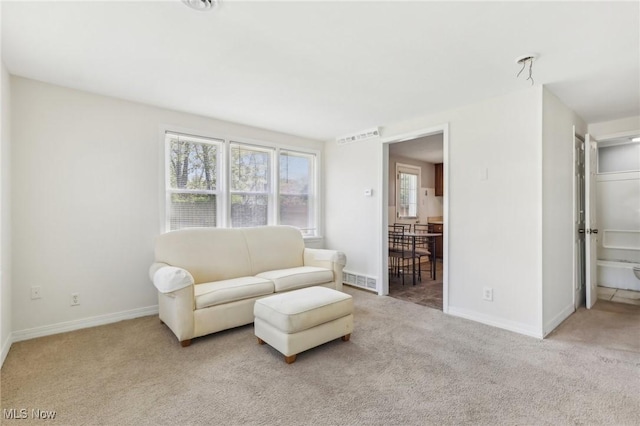 living room with baseboards, carpet flooring, and visible vents