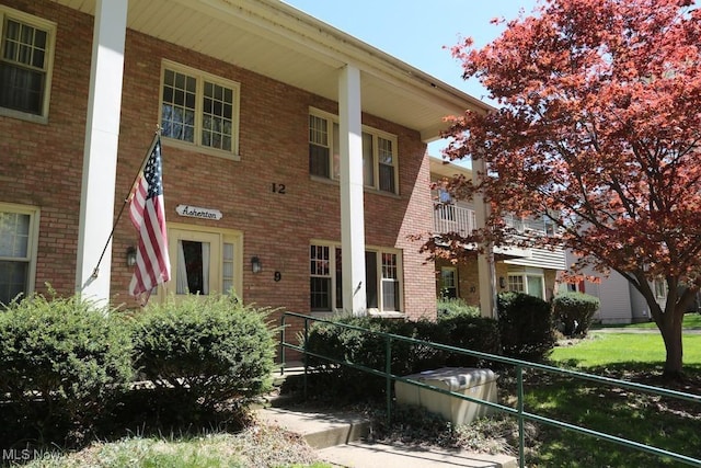 view of front of house featuring a porch and brick siding