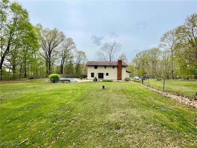 1995 Claus Rd, Vermilion, OH 44089 - rear view of property featuring a lawn, fence, and stucco siding