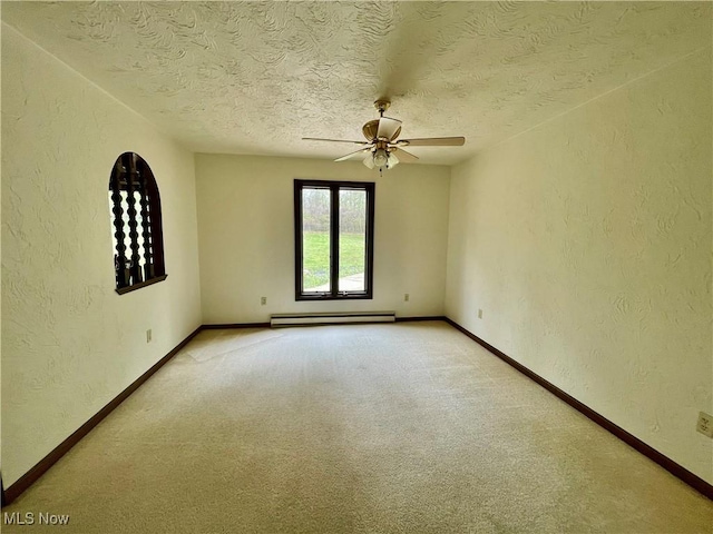 1995 Claus Rd, Vermilion, OH 44089 - unfurnished room featuring a baseboard radiator, a textured wall, and a ceiling fan