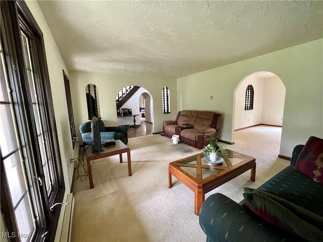 1995 Claus Rd, Vermilion, OH 44089 - carpeted living area with arched walkways, a textured ceiling, and a wealth of natural light