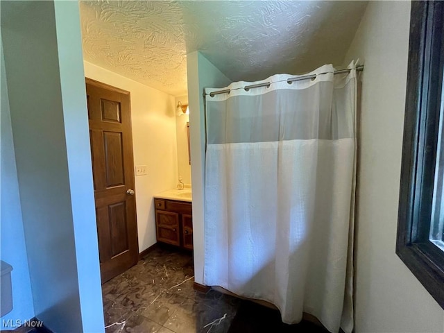 1995 Claus Rd, Vermilion, OH 44089 - bathroom featuring vanity, a textured ceiling, and a shower with shower curtain