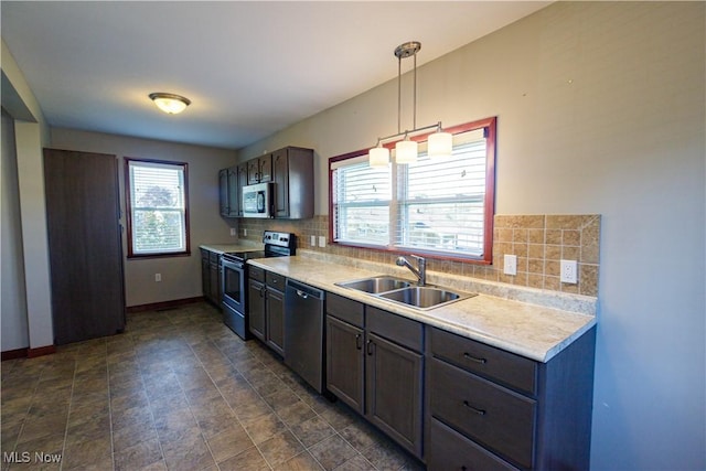 kitchen with light countertops, a sink, tasteful backsplash, and stainless steel appliances