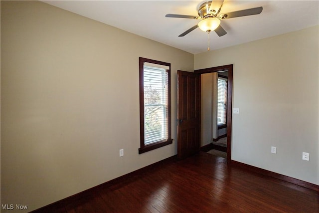 unfurnished room featuring baseboards, ceiling fan, and wood finished floors