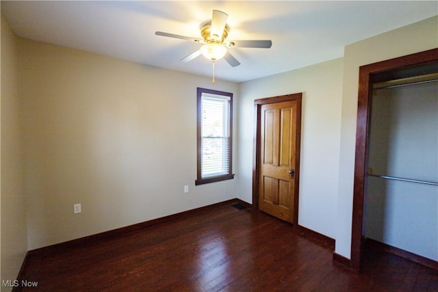 unfurnished bedroom with a ceiling fan, baseboards, wood finished floors, and a closet