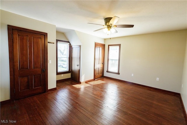 empty room featuring wood-type flooring, baseboards, and ceiling fan