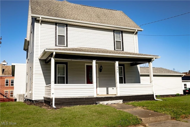 view of front of house featuring a front lawn, roof with shingles, and covered porch
