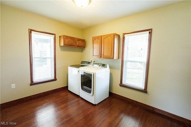 laundry room with plenty of natural light, dark wood-style floors, cabinet space, and washer and dryer