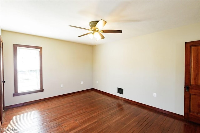 unfurnished room with baseboards, ceiling fan, hardwood / wood-style flooring, and visible vents