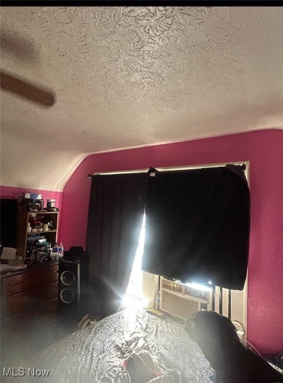 interior details featuring cooling unit and a textured ceiling