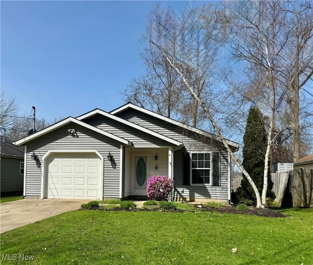 view of front of home with fence, driveway, a front yard, and a garage