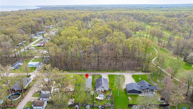 aerial view featuring a residential view and a wooded view