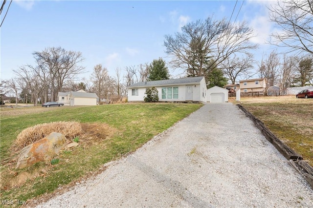 449 W Long Lake Blvd, Akron, OH 44319 - single story home featuring an outdoor structure, driveway, a front yard, and a detached garage