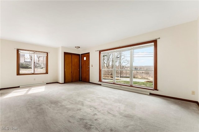 449 W Long Lake Blvd, Akron, OH 44319 - unfurnished living room with light colored carpet, baseboards, and a baseboard heating unit
