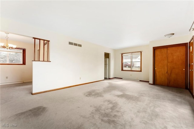 449 W Long Lake Blvd, Akron, OH 44319 - unfurnished room with visible vents, a notable chandelier, a wealth of natural light, and light colored carpet